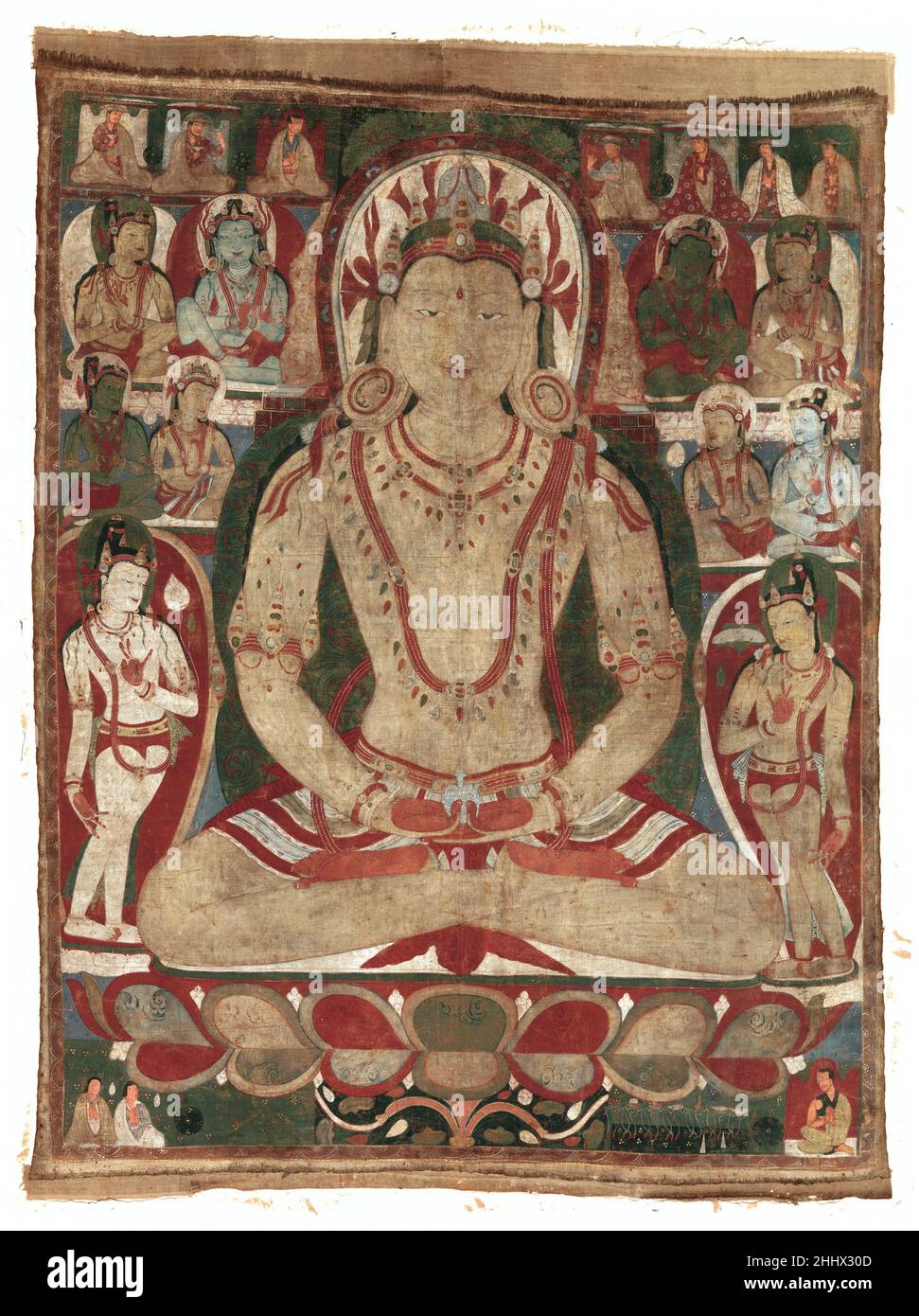 The Buddha Amitayus Attended by Bodhisattvas 11th or early 12th century Tibet The cult of Amitayus, the Buddha of Eternal Life, was popular in Tibet, where his followers believed that devotion to this Buddha would prolong life. Amitayus is shown holding a jar containing the elixir of immortality, amrita, in his lap. He is richly bejeweled and has a golden complexion, creating radiance appropriate to his transcendent nature. He mediates in a heavenly assembly of bodhisattvas, flanked by two standing bodhisattvas typical of medieval eastern Indian art and an array of seated bodhisattvas who rece Stock Photo