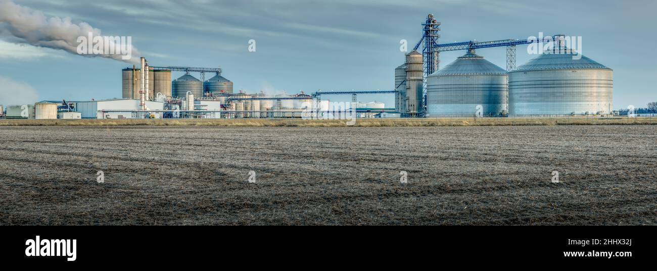 Ethanol plant in an agricultural landscape. Corn has become a part of our energy assets. Stock Photo