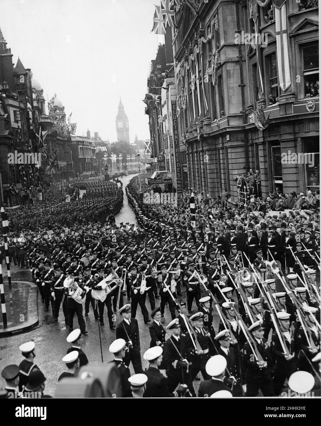 The armed service march along Whitehall after the Coronation of Queen Elizabeth II  at Westminster Abbey. The Contingent of the Royal Navy and Royal MarinesThe Officer Commanding the Contingent, Captain V. C. Begg, D.S.O., D.S.C., R.N. With detachments from: Royal Marines and Royal Marines Forces Volunteer Reserve. Followed by First Detachment of the Foot Guards The Officer Commanding the First Detachment, Lieut-Colonel B. O. P. Eugster, D.S.O., M.C., Irish Guards leading the Band of the Welsh Guards, Band of the Irish Guards, The Corps of Drums of the 1st Bn. Welsh Guards and the Corps of Dru Stock Photo