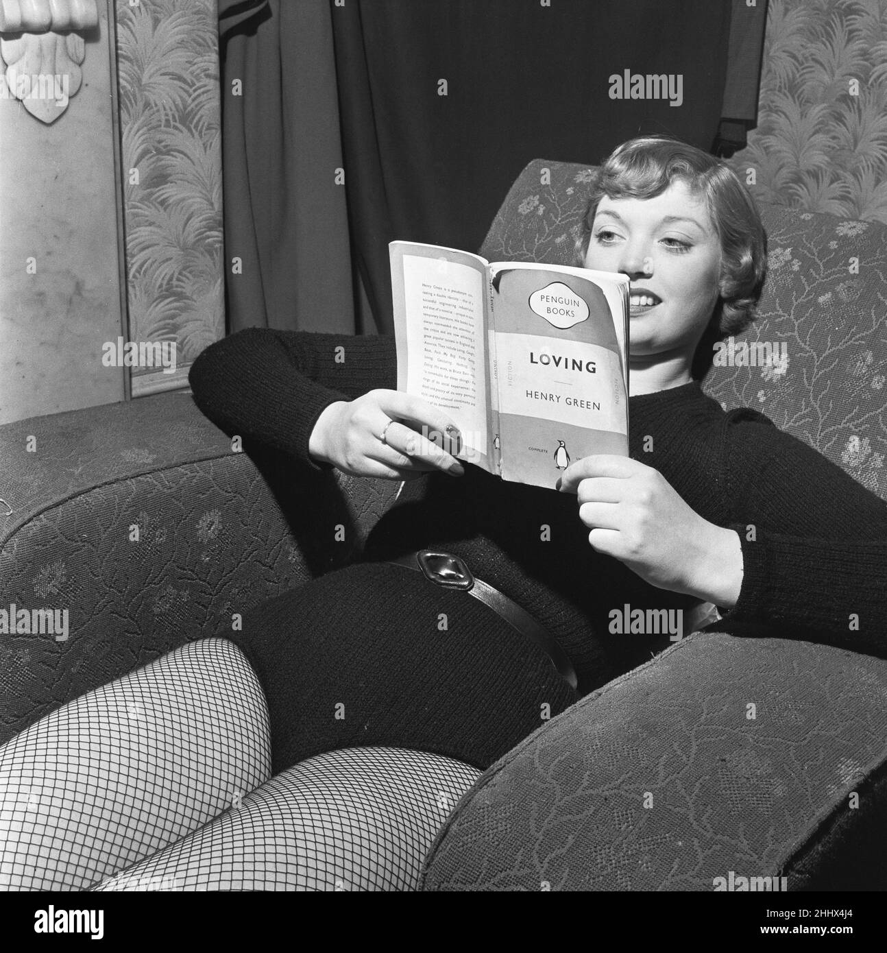 Back stage with the show girls during the rehearsal of Tom Arnold's Chu Chin Chow at the Empire Theatre,  Sunderland,. T'he girl taking it easy is Pauline Jones, of Birmingham. She is twenty and she is a skater in an iceshow. And while she's waiting for the show to begin, she likes to relax with a book. 'Don't be fooled by the title,' says Miss Jones. 'It happens to be a very good novel.' 28th April 1954 Stock Photo
