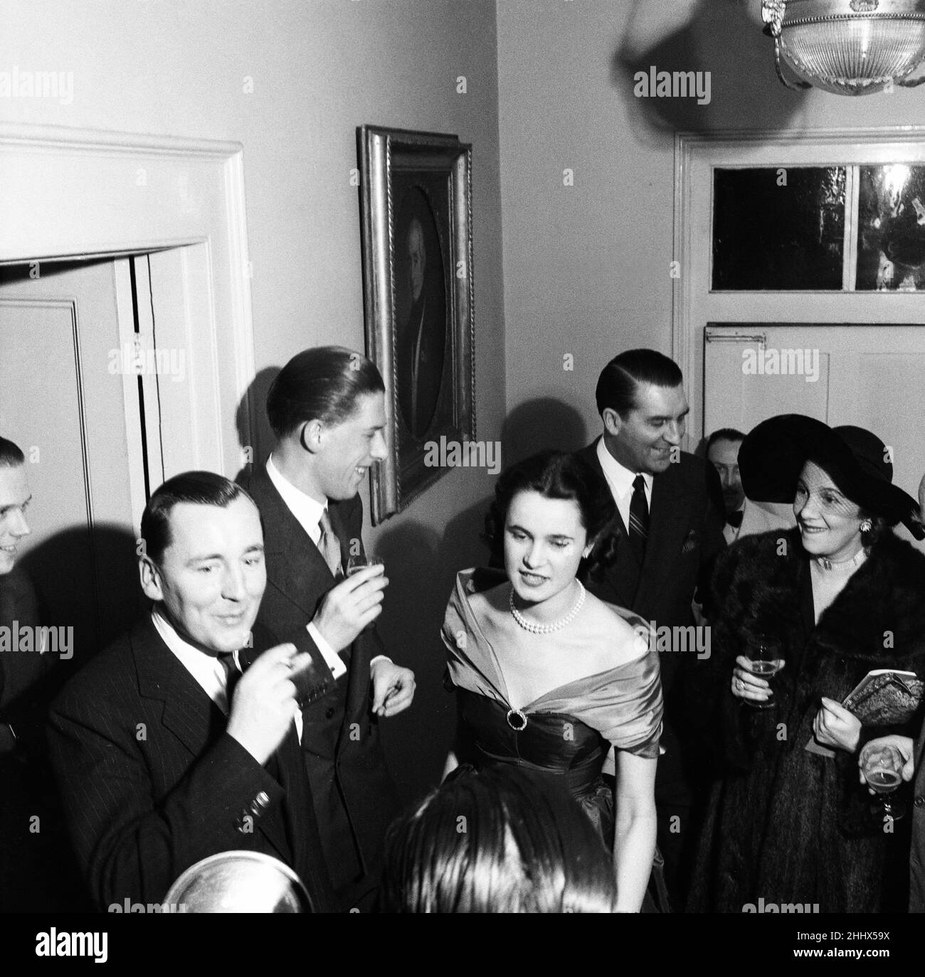 George Henry Hubert Lascelles, 7th Earl of Harewood, & Countess of Harewood hold cocktail party to celebrate the birth of the Earl's magazine Opera, pictured February 1950.   The party was held at the home of 'Opera' art editor, Richard Burkle, at Bloomfield terrace London.   Also pictured:  Joan Cross opera singer Benjamin Britten composer Stock Photo