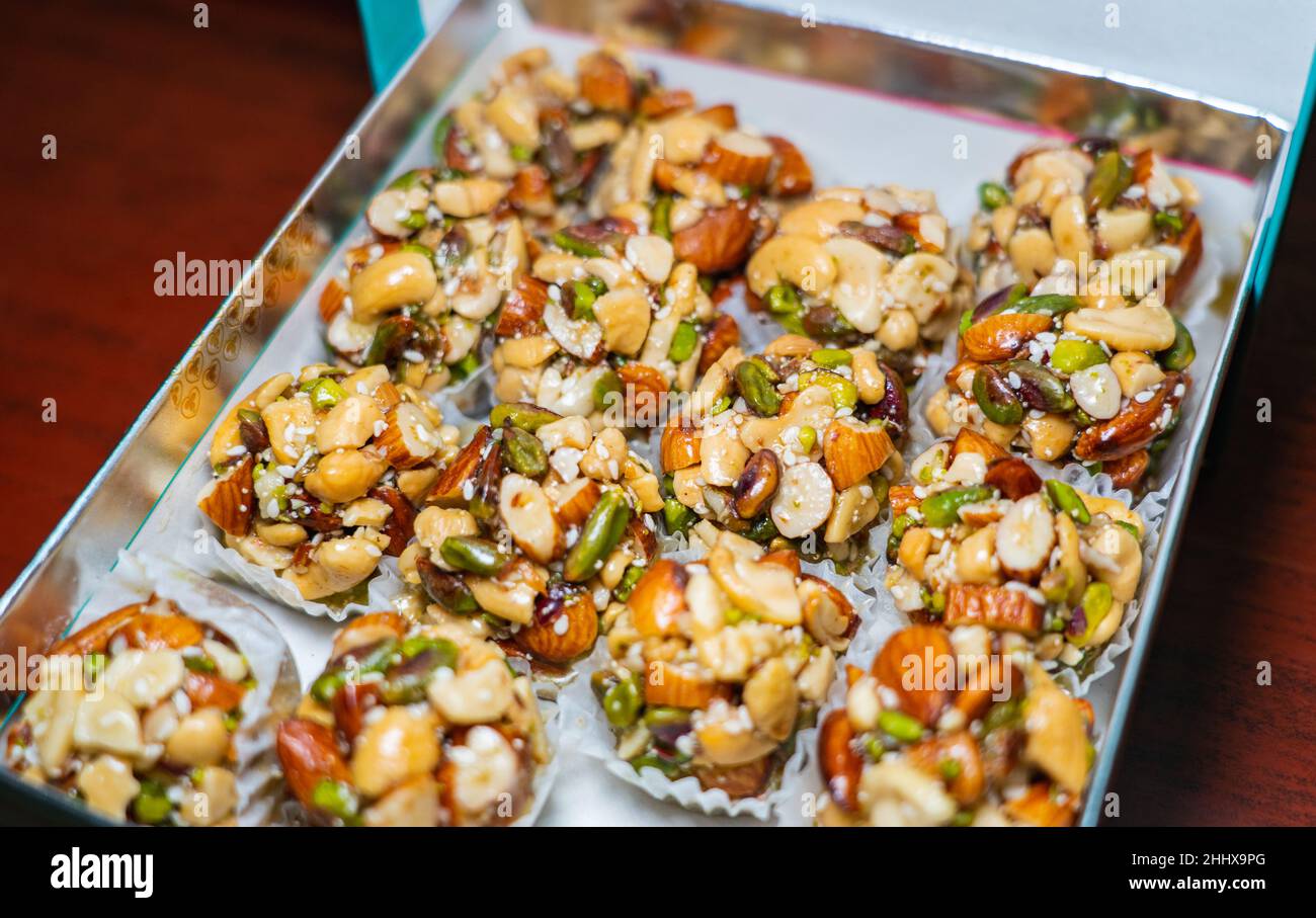 Selective focus of nuts laddu in a sweet box. Stock Photo