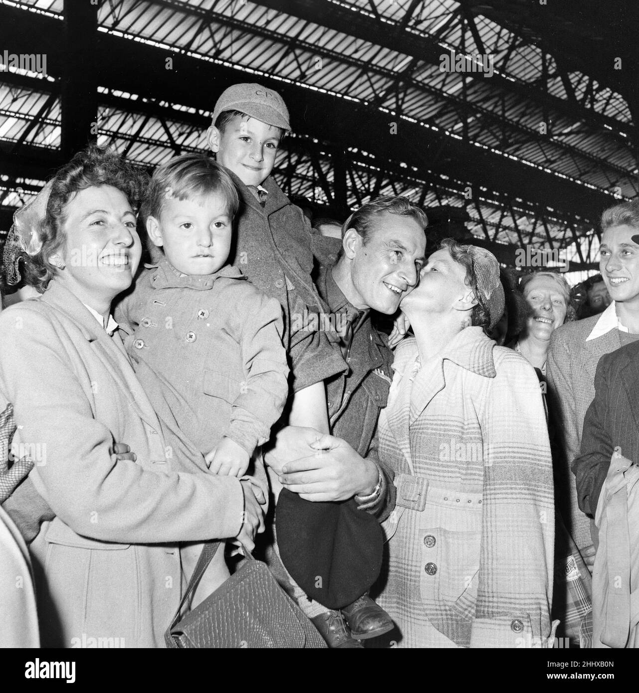 British Prisoners of war released from Korea, pictured on their return to Southampton where they docked from the Asturius. Corporal Upjohn of the Gloucester regiment is greeted by his family at the sheds in Southampton. 16th September 1953. Stock Photo