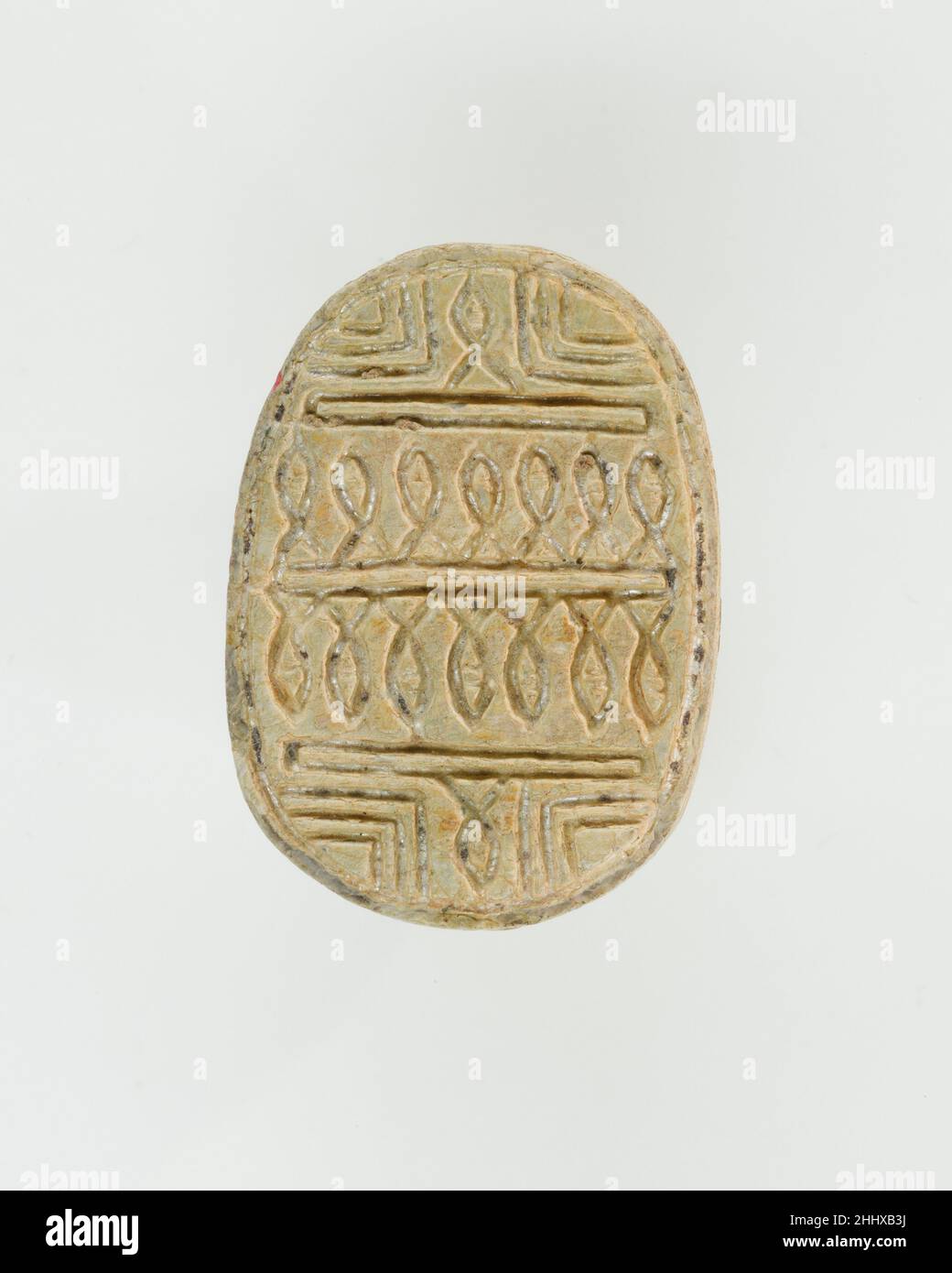 Scarab Decorated with Loops ca. 1770–1670 B.C. Middle Kingdom Designs with twirling continuous lines and coils, sometimes forming complicated woven patterns, appear on scarabs in the early Middle Kingdom and become particularly popular from the later part of Dynasty 12 onward, during the late Middle Kingdom (late Dynasty 12–Dynasty 13, ca. 1850–1640 B.C.). In some cases they are accompanied by hieroglyphs with protective meaning. Soon afterwards, these often complex linear designs were imitated on Canaanite scarabs of the Middle Bronze Age (contemporary with the Second Intermediate Period in E Stock Photo
