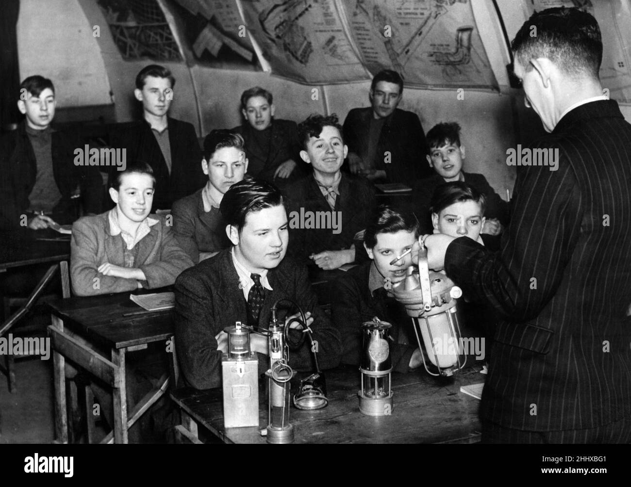 Proper training for boys joining the mining industry. Picture shows a class at the Easington Residential Training Centre being given a practical lecture on various types of pit lamps. Circa 1948. Stock Photo