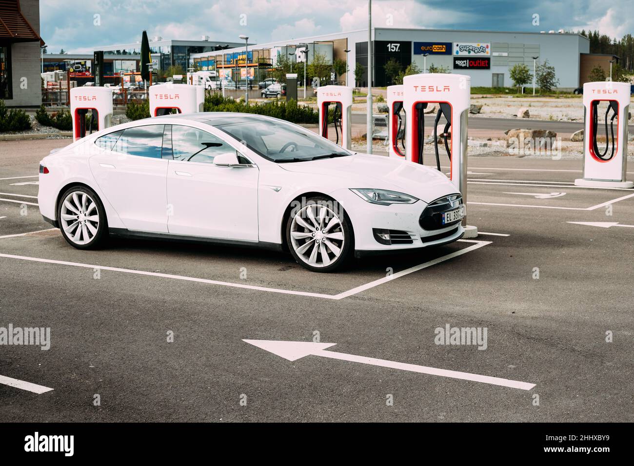 White Color Tesla Model S P85 Car Parked At Charging Station. The Tesla Model S Is A Full-sized ...