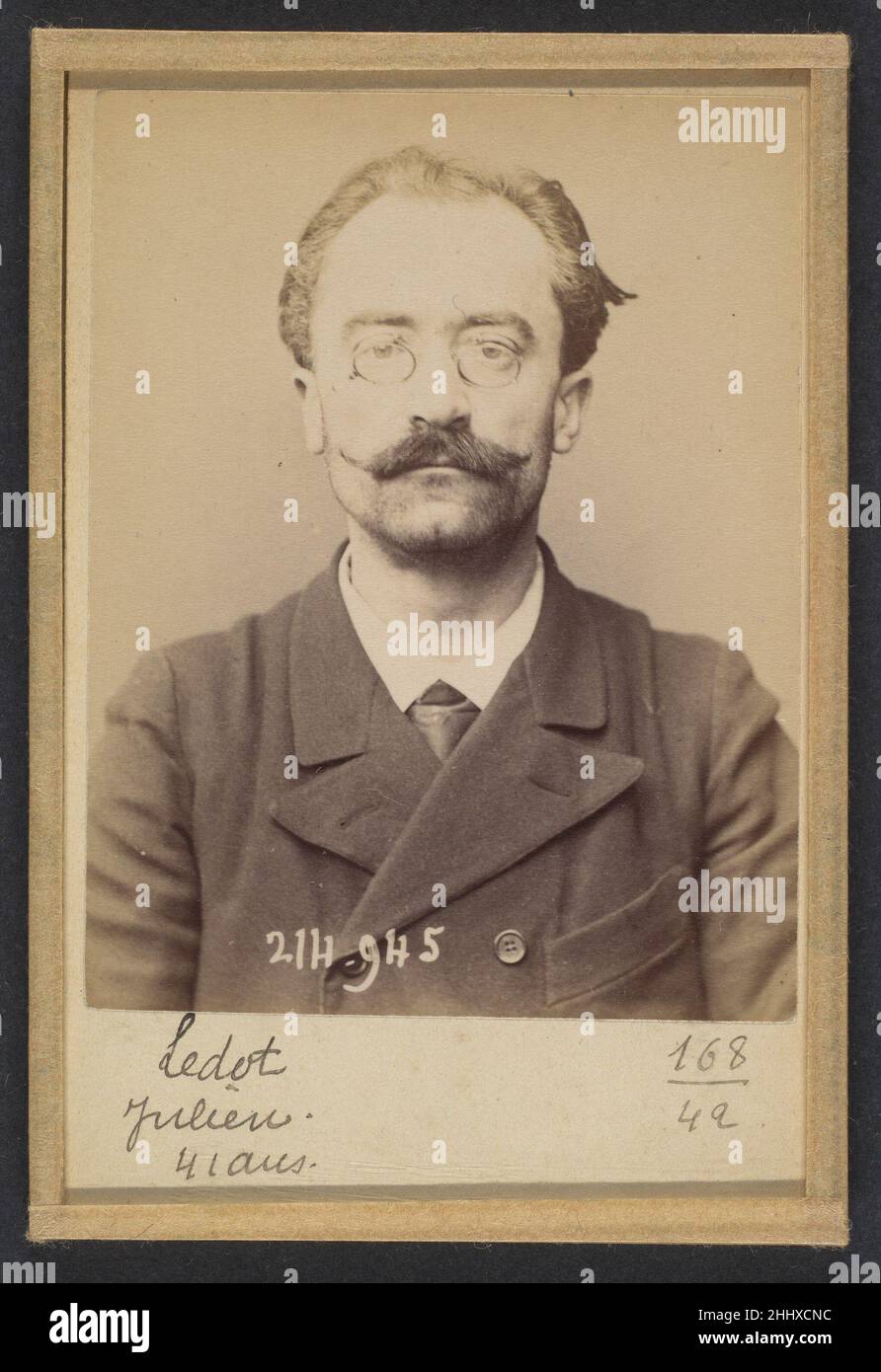 Ledot. Julien. 41 ans, né à Bourges (Cher). Employé. Anarchiste. 1/3/94. 1894 Alphonse Bertillon Born into a distinguished family of scientists and statisticians, Bertillon began his career as a clerk in the Identification Bureau of the Paris Prefecture of Police in 1879. Tasked with maintaining reliable police records of offenders, he developed the first modern system of criminal identification. The system, which became known as Bertillonage, had three components: anthropometric measurement, precise verbal description of the prisoner’s physical characteristics, and standardized photographs of Stock Photo