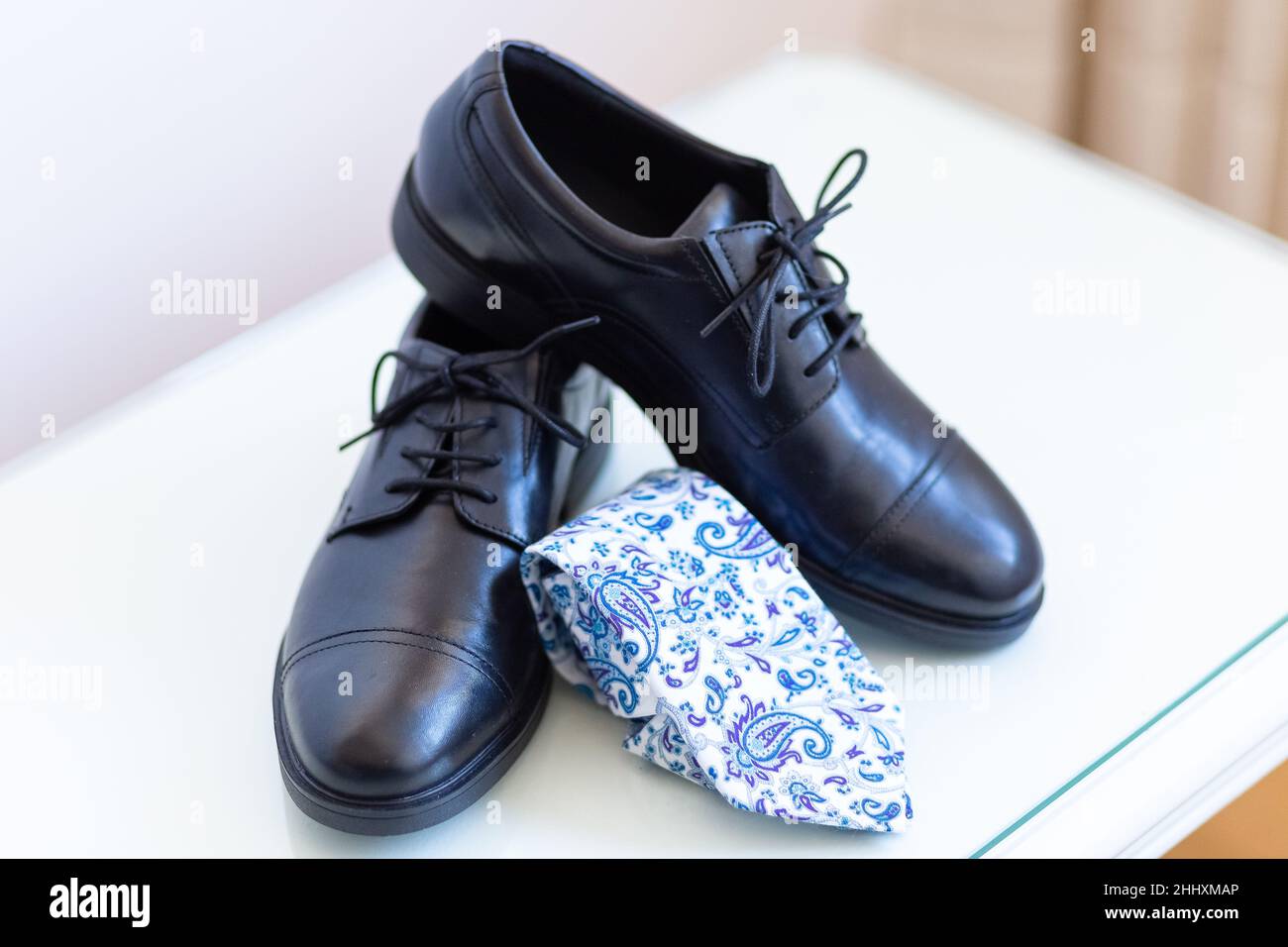Some classic leather shoes and a tie prepared for the wedding Stock Photo