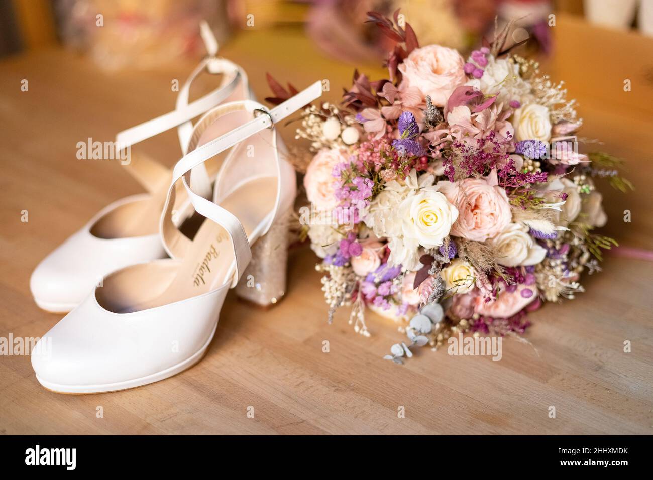 The bridal shoes with a wedding bouquet on the floor Stock Photo