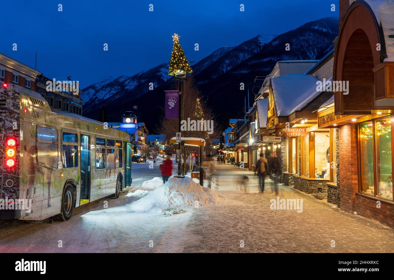 Banff, Alberta, Canada - January 10 2022 : Bus stop on Banff Avenue in winter night. Stock Photo
