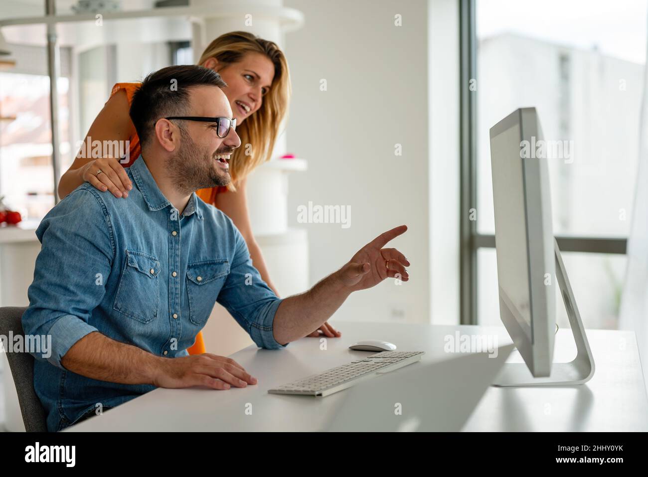 Happy couple doing business together working at small office Stock Photo