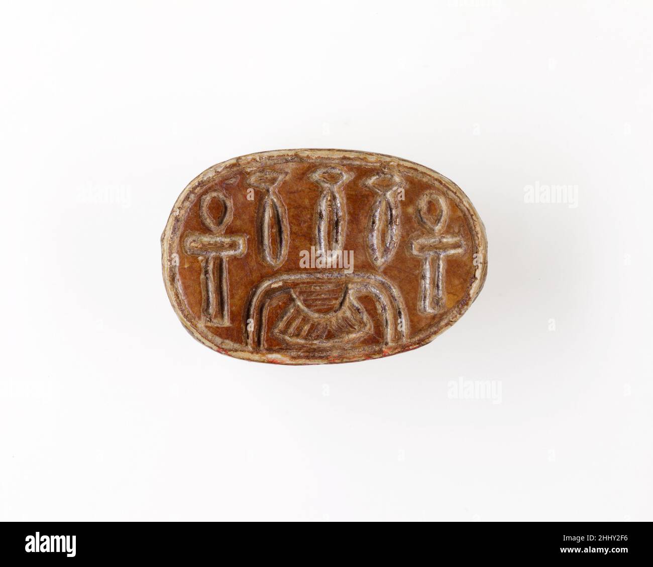 Scarab Inscribed with Hieroglyphs ca. 1850–1640 B.C. Middle Kingdom The majority of design scarabs of the late Middle Kingdom (late Dynasty 12–Dynasty 13, ca. 1850 –1640 B.C.) are decorated with symmetric compositions of hieroglyphs and/or scrolls. These signs are not meant to form words but are chosen for their positive, protective meaning. This scarab shows the hieroglyph for gold (nub) and signs placed above it, in pairs to form a balanced composition.. Scarab Inscribed with Hieroglyphs  557125 Stock Photo
