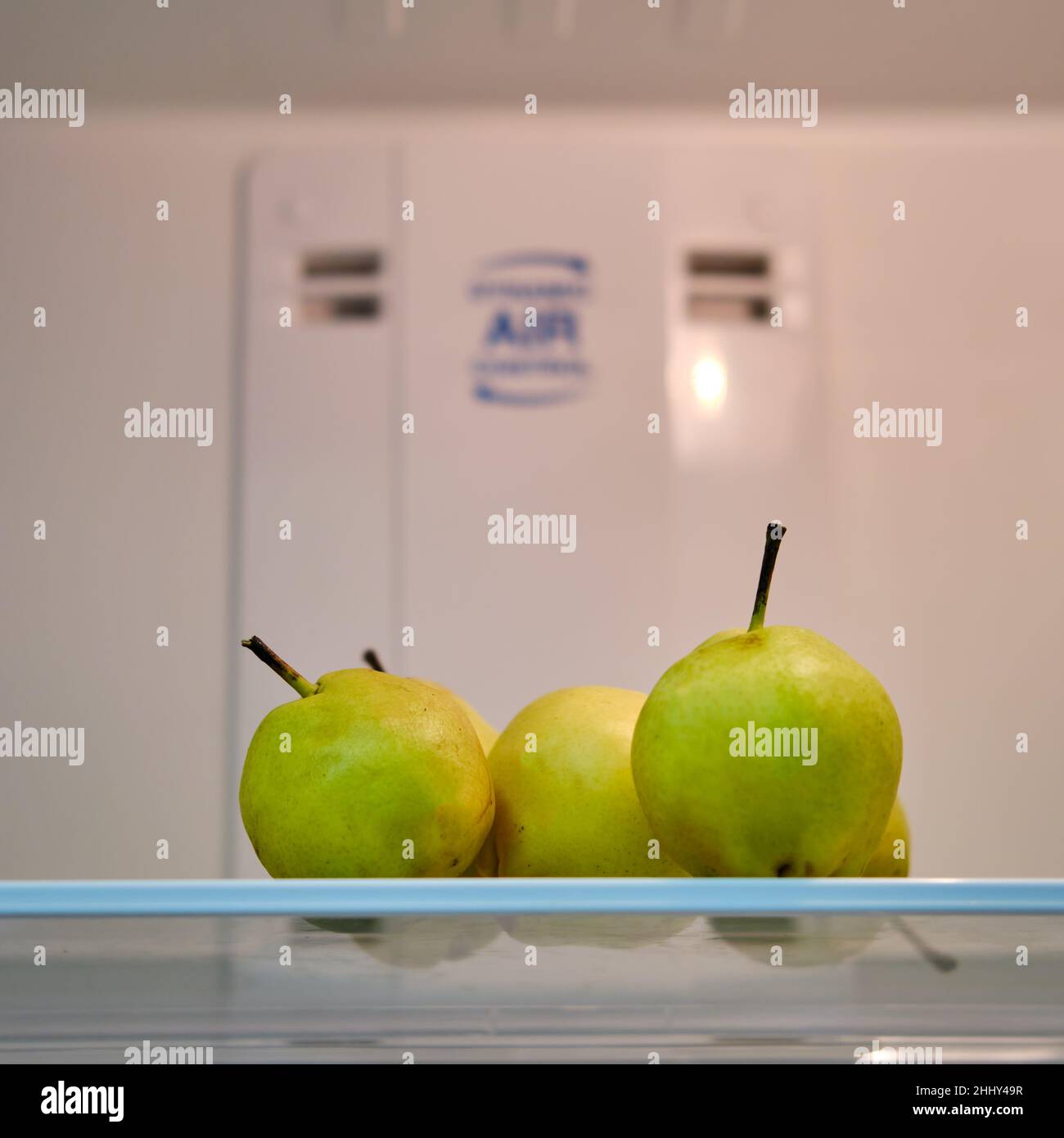 Fruit pears on a shelf in an empty white refrigerator Stock Photo Alamy