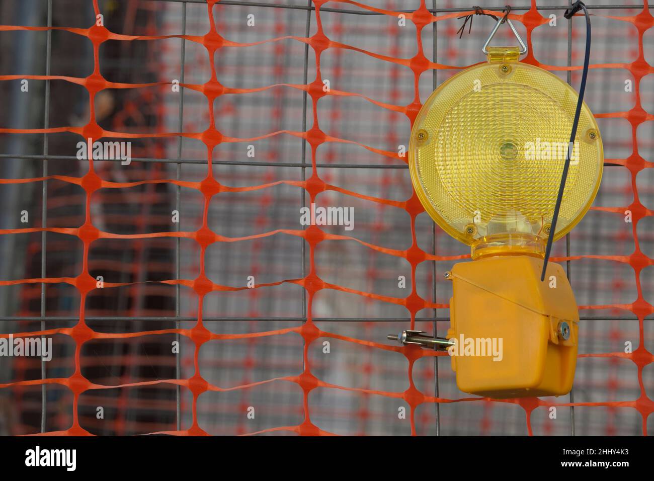 Emergency Flashing LED hanging on welded Wire. Construction site