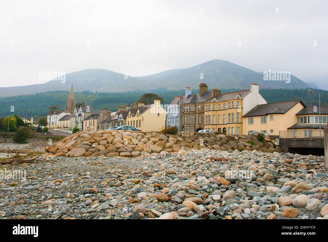 A view of the Mountains of Mourne  and Tollymore Forest Park from the stony breakwater on the beach at Newcastle County Down in Northern Ireland Stock Photo