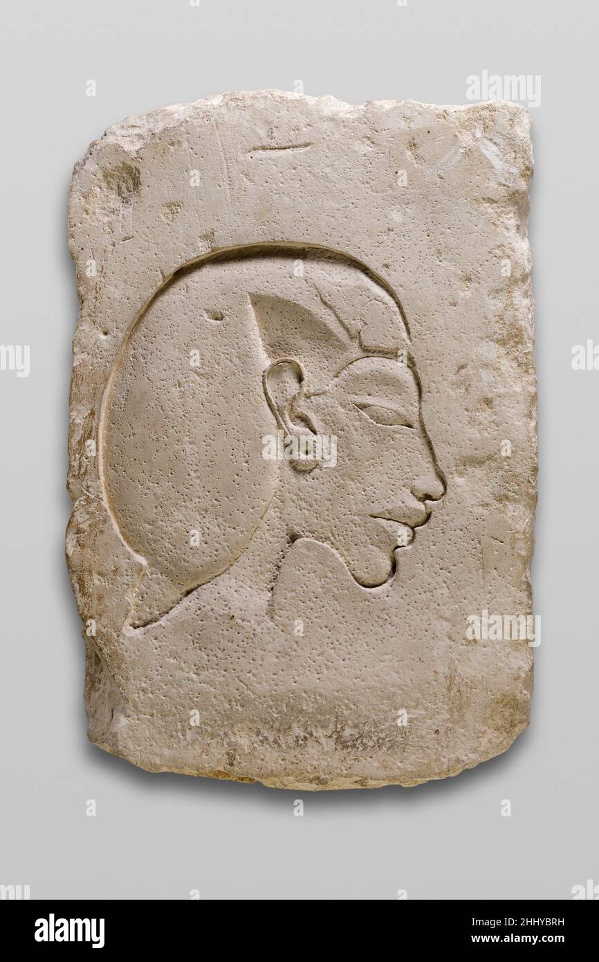 Trial Piece with Relief of Head of Akhenaten ca. 1353–1336 B.C. New Kingdom, Amarna Period The slanting slitted eye, heavy everted lips, and drooping chin here recognizably signify the pharaoh Akhenaten.This piece is a 'sculptor's model' from Amarna. Such models are roughly rectangular slabs of stone on which the representation is theorized to be a master's model for his assistants to follow while decorating a wall with relief or, alternatively, an apprentice's study piece. At least in some instances, however, such pieces may have been intended or served secondarily as donations. For instance, Stock Photo