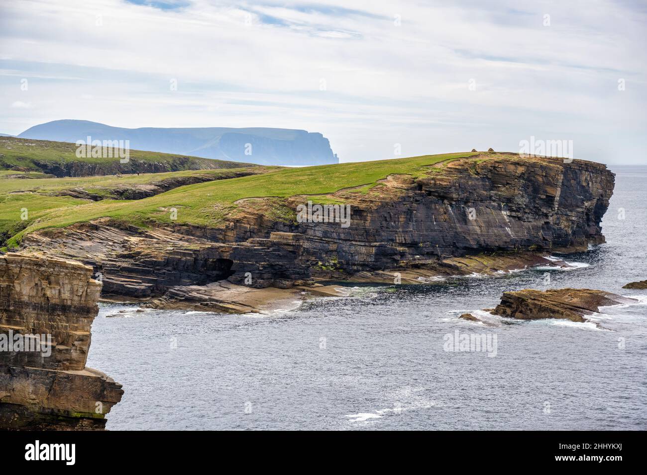 Yesnaby coastline looking south towards Brough of Bigging headland with distant view of Hoy - west coast of Mainland Orkney in Scotland Stock Photo