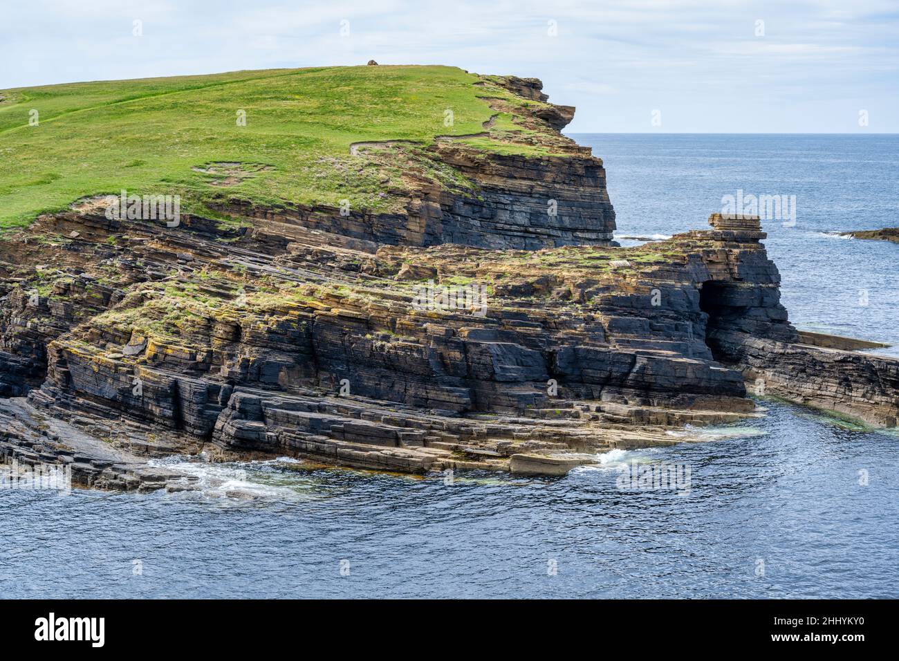 View looking across sheltered inlet to Brough of Bigging headland on Yesnaby coastline on west coast of Mainland Orkney in Scotland Stock Photo