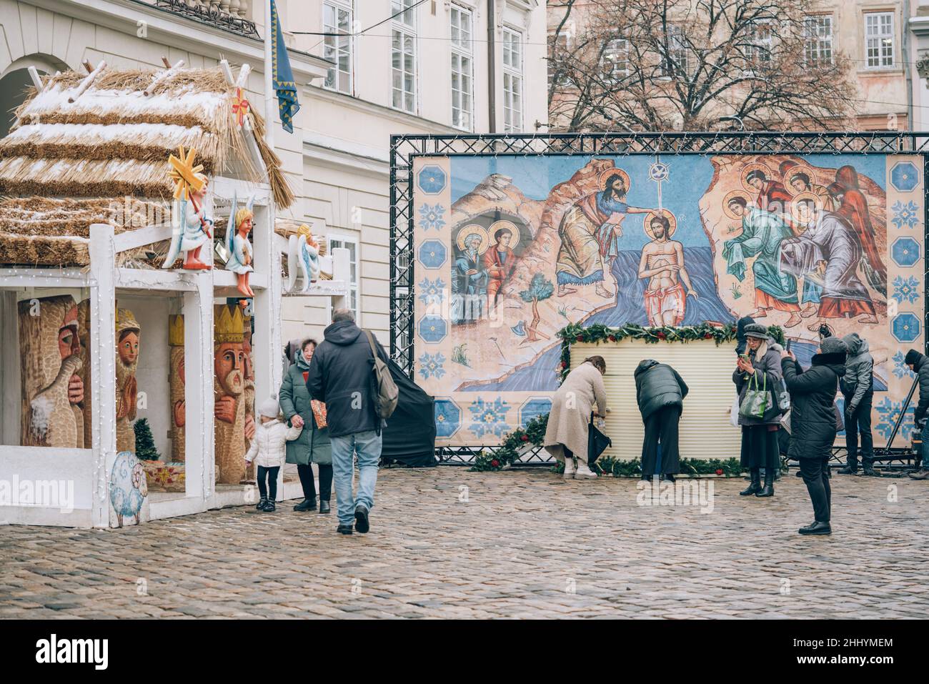 Lviv, Ukraine - January 19, 2022 : Orthodox holiday of Epiphany. People collecting consecrated holy water in bottles and containers near town hall to Stock Photo