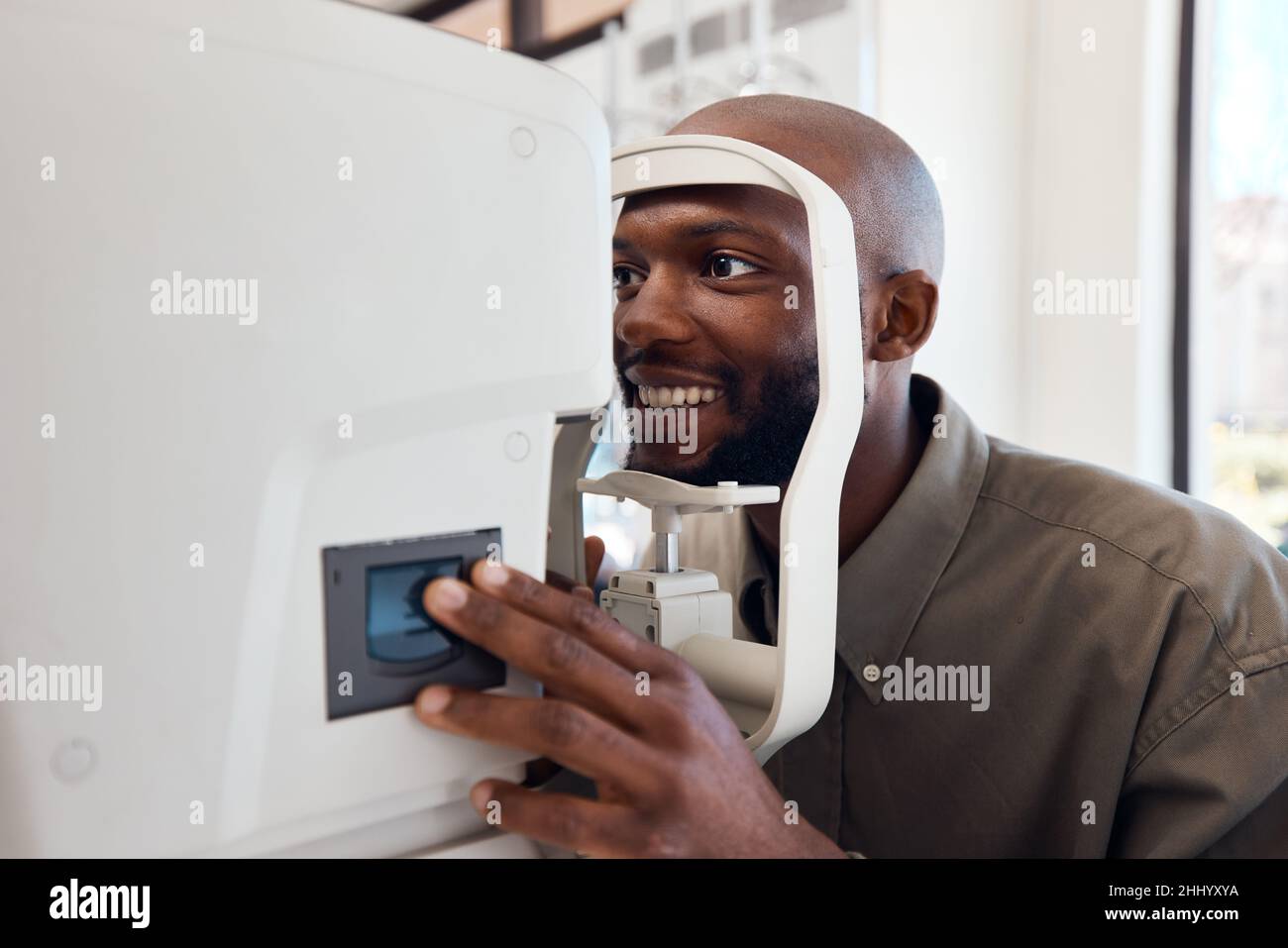 Seeing better starts right now. Shot of a young man getting his eyes examined with an autorefractor. Stock Photo