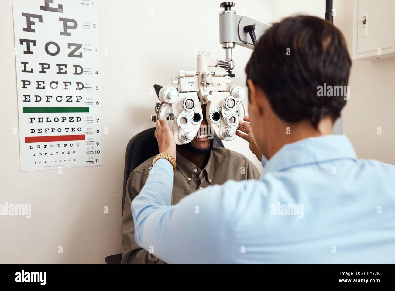 It's always worth seeing an optometrist. Shot of an optometrist examining her patients eyes with an optical refractor. Stock Photo