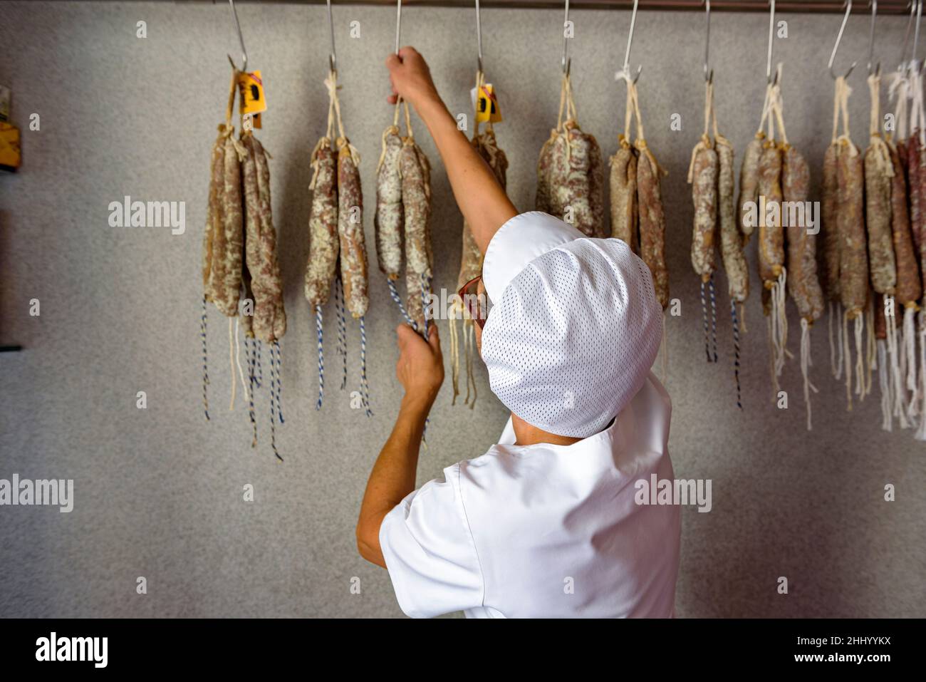 Long pork sausages (longaniza) and cold meat (fuet) in a pork butcher's in Prats de Lluçanès (Osona, Barcelona, Catalonia, Spain) ESP: Embutidos Stock Photo