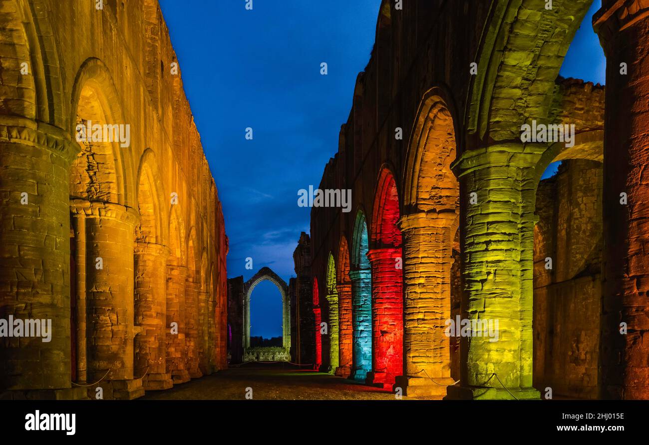 Ancient 12th Century Fountains Abbey bathed in incandescent light on