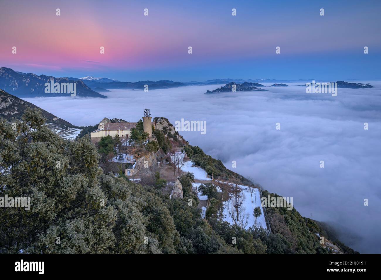 Queralt Sanctuary in a winter sunset with a sea of clouds over Berga (Berguedà, Catalonia, Spain, Pyrenees) ESP: Santuario de Queralt al atardecer Stock Photo