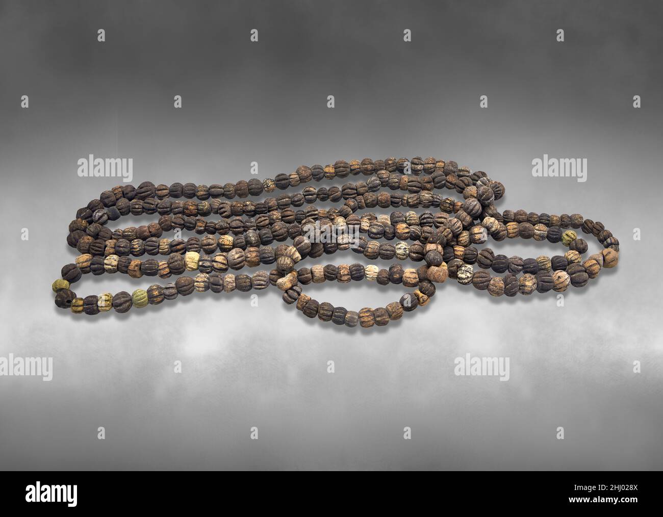 Mycenaean jewellery - glass bead necklace, cemetery at Dendra, chamber tomb 10. Naflion Archaeo;ogical Museum. . Against grey background. Photographer Stock Photo
