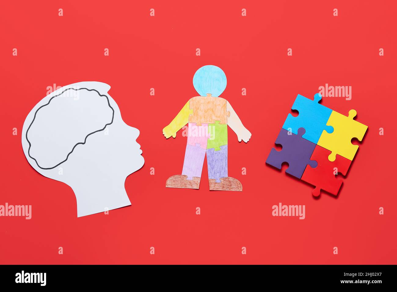 Paper head and colorful human figure with puzzle pieces on color