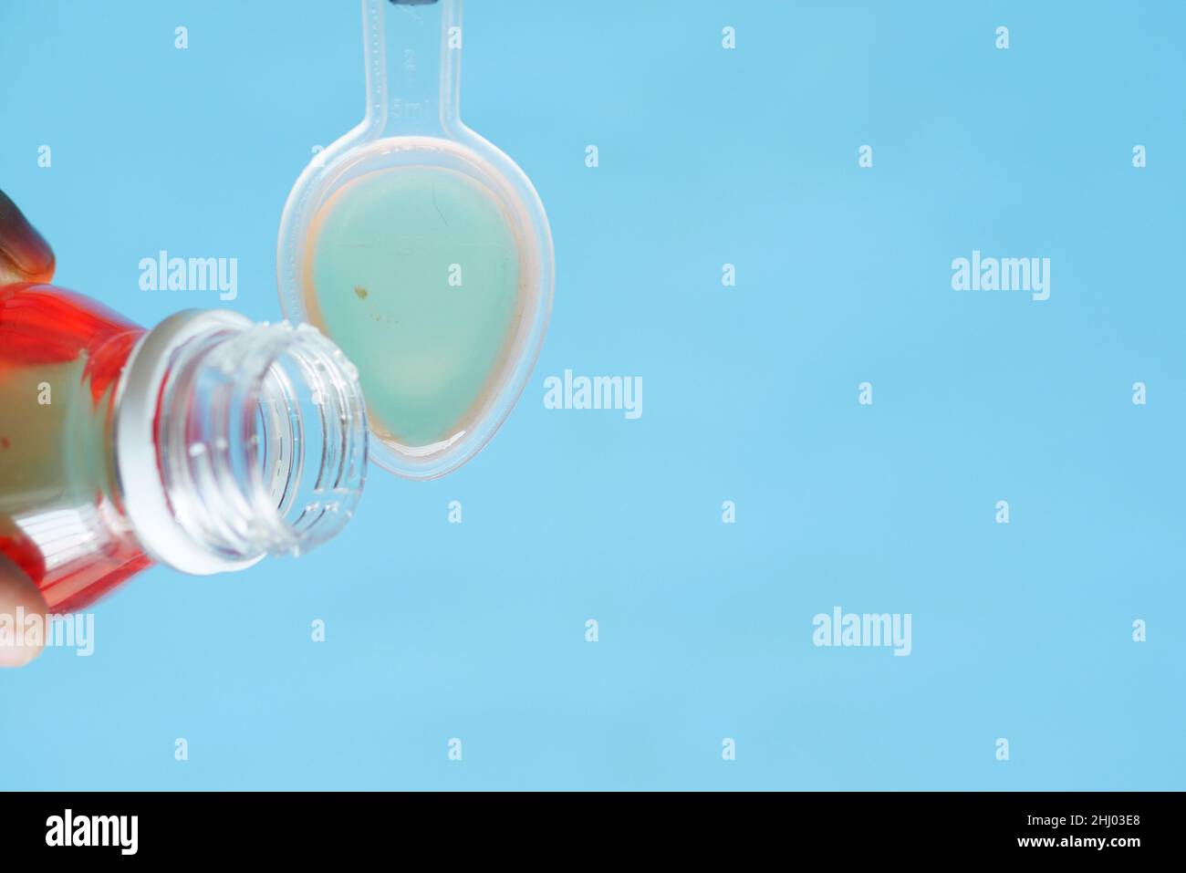 pour liquid medicine on top of spoon Stock Photo Alamy