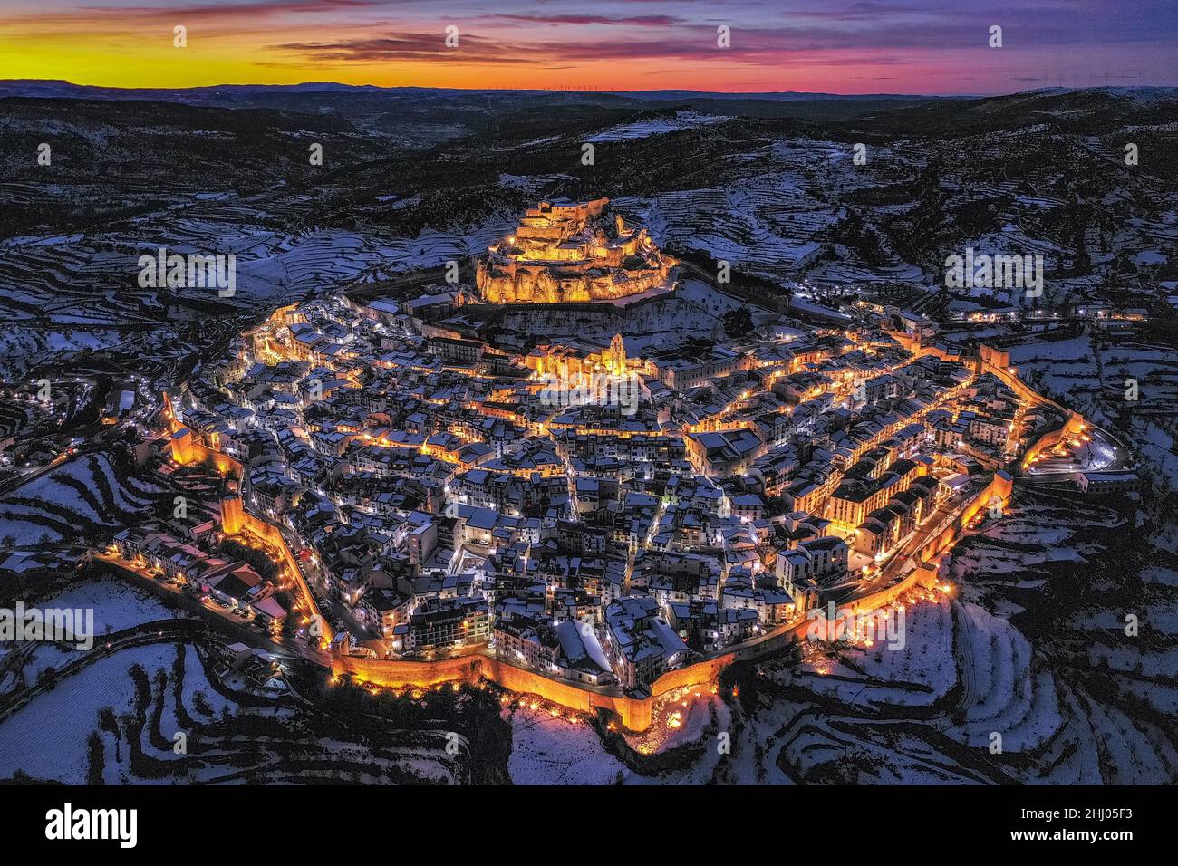 Morella medieval city aerial view, in a winter twilight - blue hour, after a snowfall (Castellón province, Valencian Community, Spain) Stock Photo