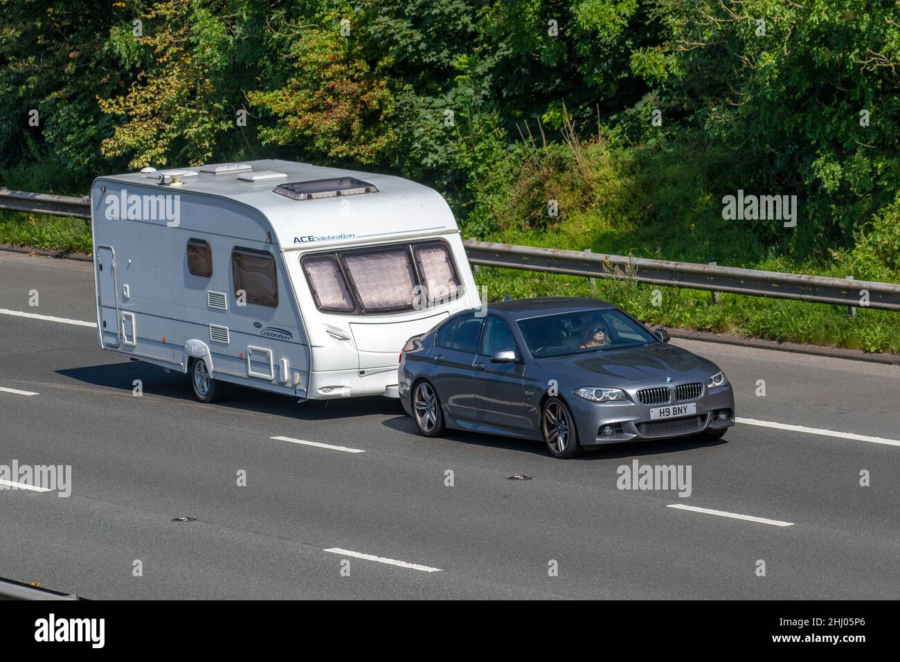 2013 grey BMW 520 520D 1995cc 8 speed automatic towing ACE Celebration caravan; Caravans and Motorhomes, campervans on Britain's roads, RV leisure vehicle, family holidays, caravanette vacations, Touring caravan holiday, van conversions, Vanagon autohome, life on the road, motor caravan Stock Photo