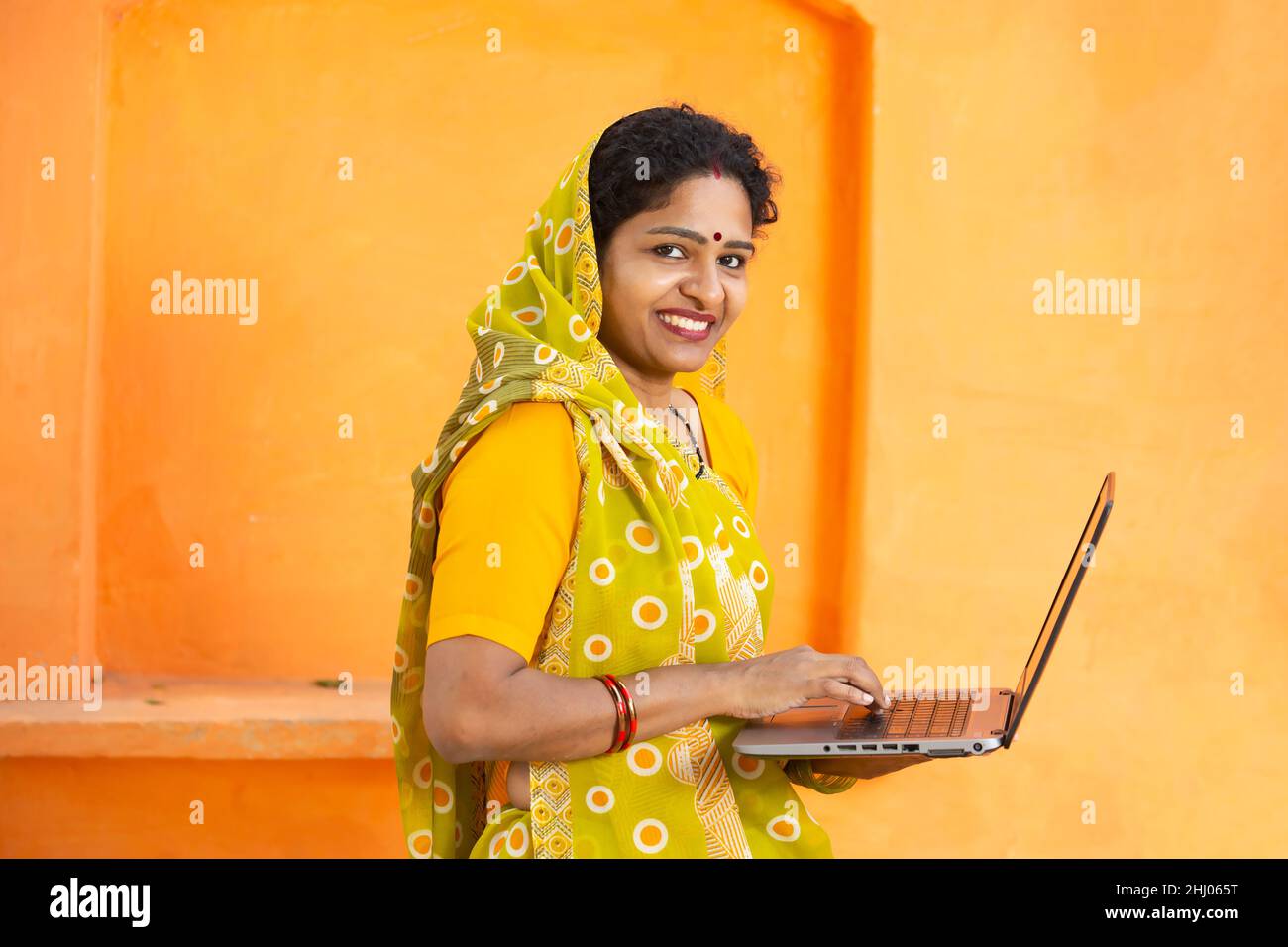 Portrait of Happy young indian woman using laptop. Smiling female ...