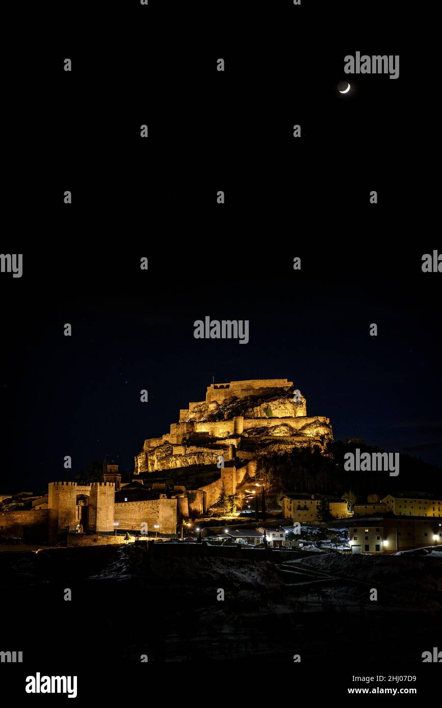 Morella medieval city in a winter night with a crescent Moon, after a snowfall (Castellón province, Valencian Community, Spain) ESP: Vista de Morella Stock Photo