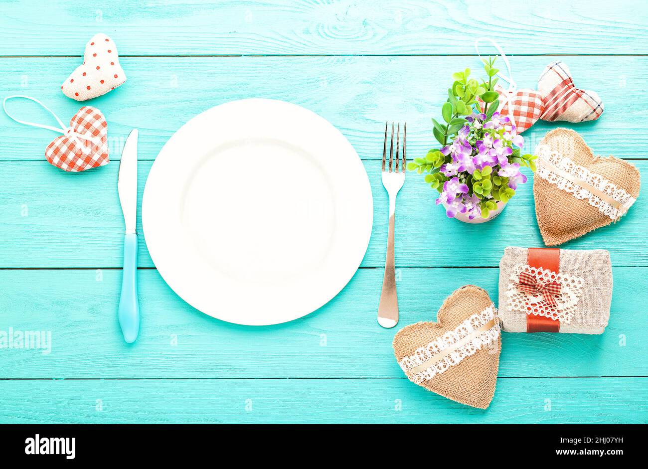 Valentines day set with silverware. Valentine day love beautiful. Romantic dinner, tableware and hearts on wooden background.Top view. Stock Photo