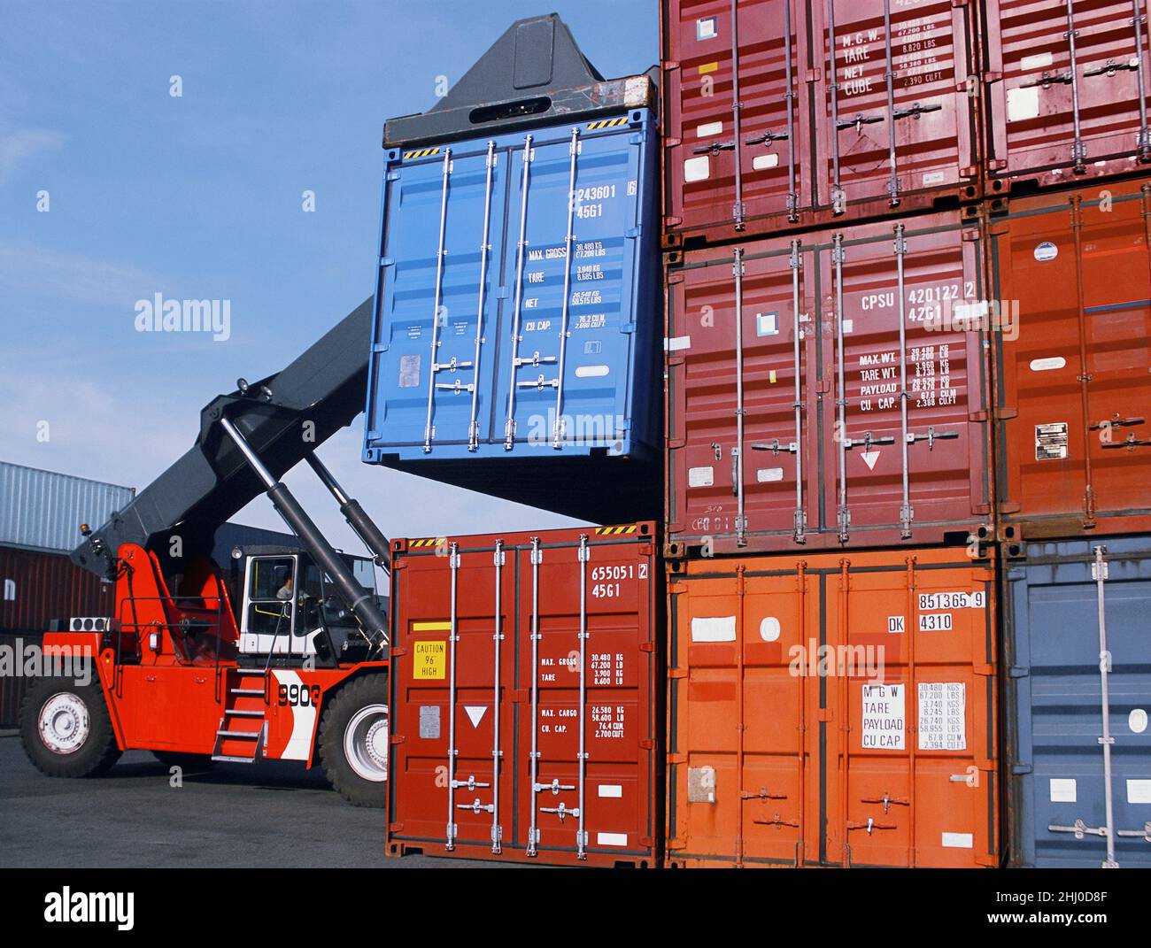 Shipping containers stacked in port. Crane stacking cargo freight