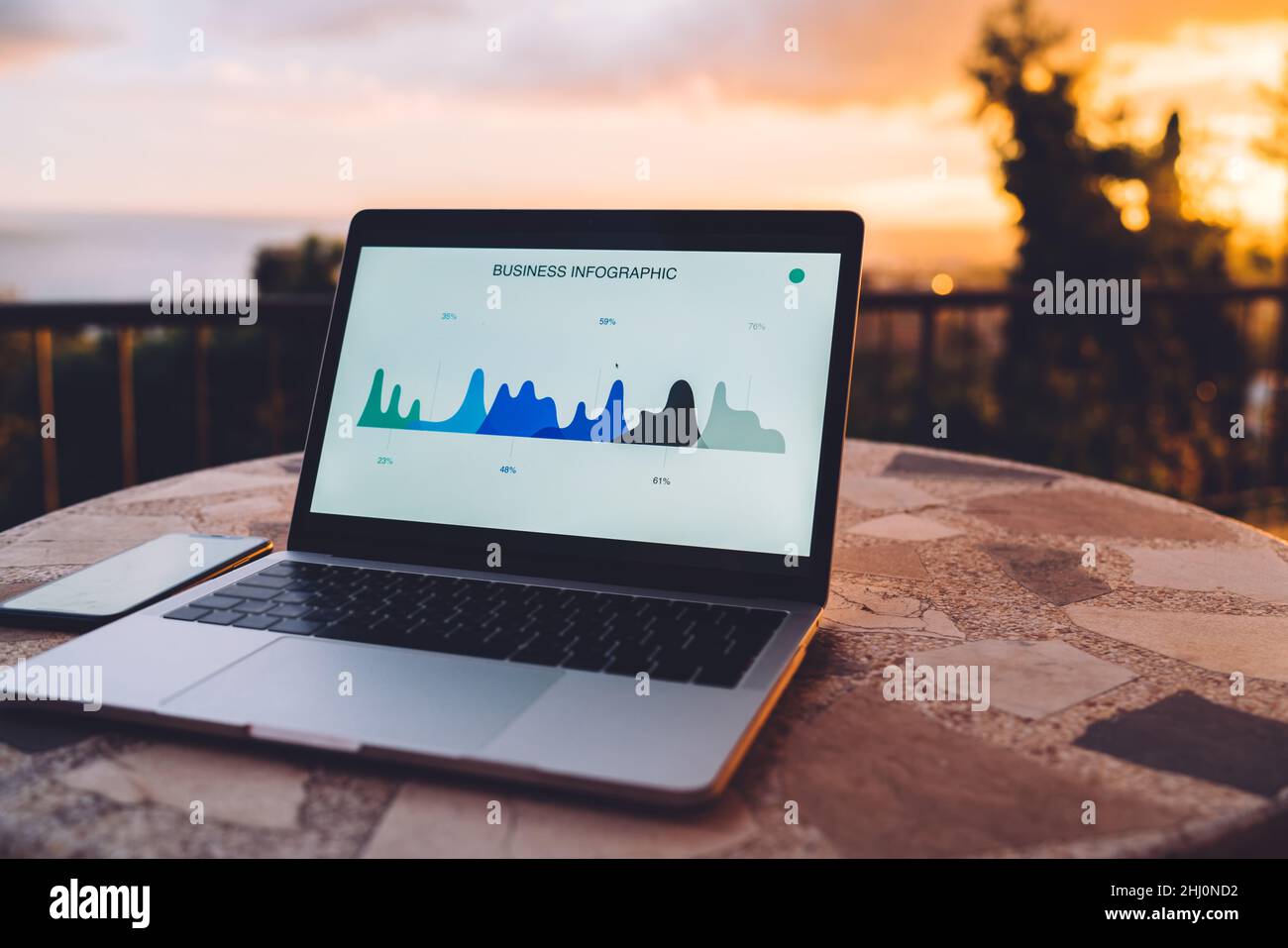 Netbook and smartphone placed on table Stock Photo
