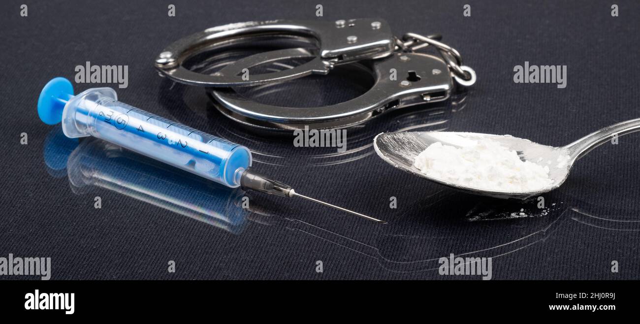 arrest for narcotic substances, handcuffs methamphetamine and syringe..... Stock Photo