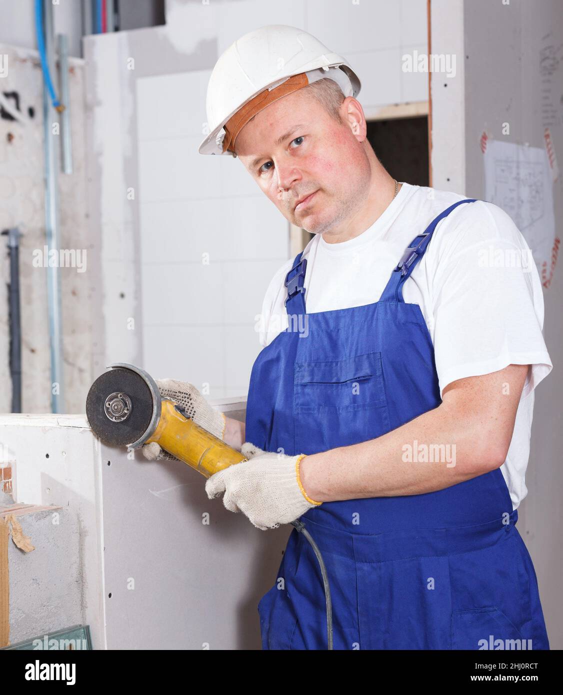 Contractor using angle grinder Stock Photo