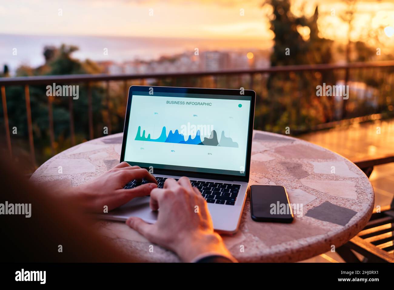 skilled financial expert checking digital marketing report during distance job at sunset Stock Photo