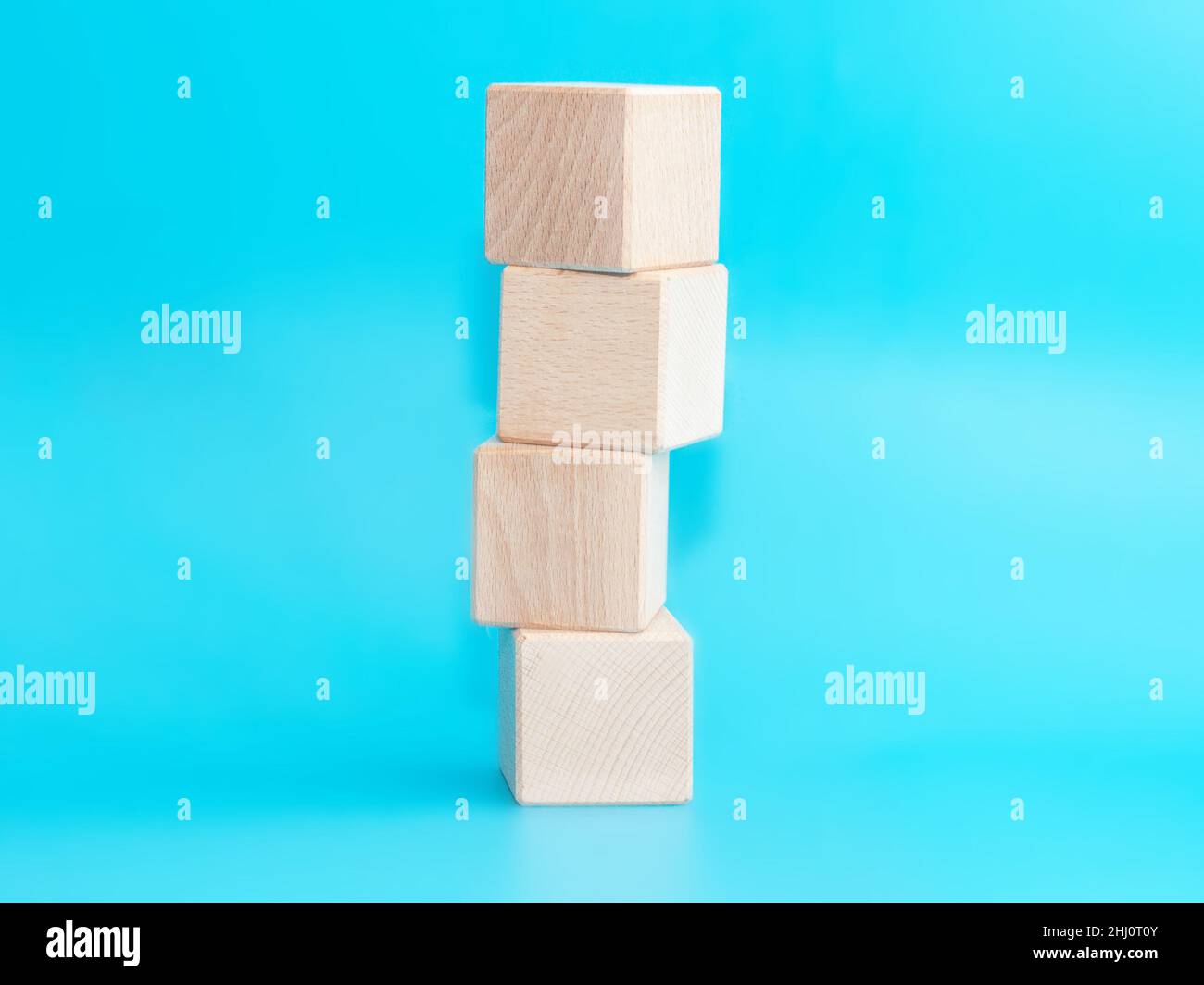 Wooden cube on blue background with space for text Stock Photo - Alamy