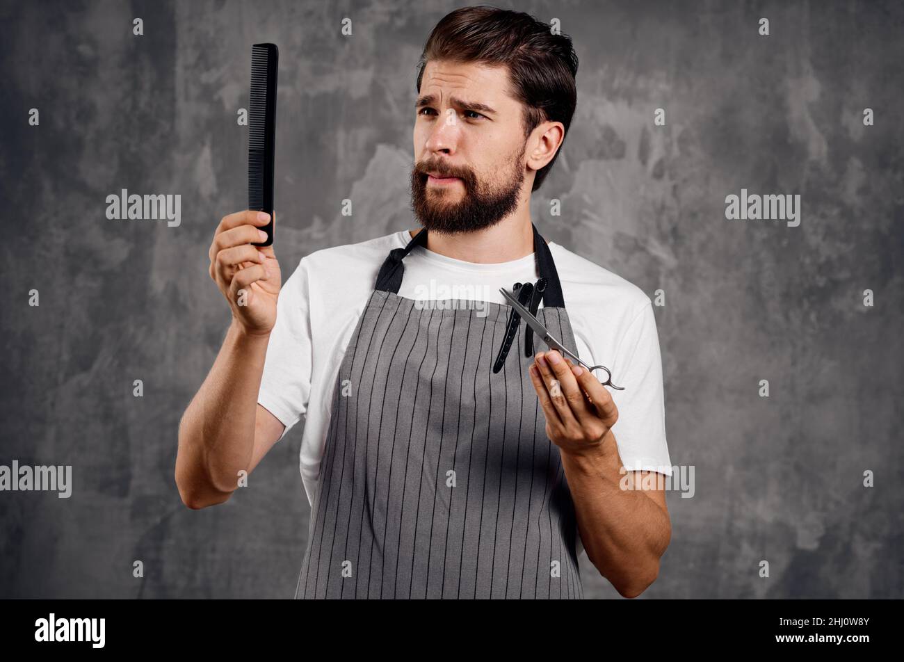 a man with a beard holds scissors and a comb in his hand hairdresser hair styling