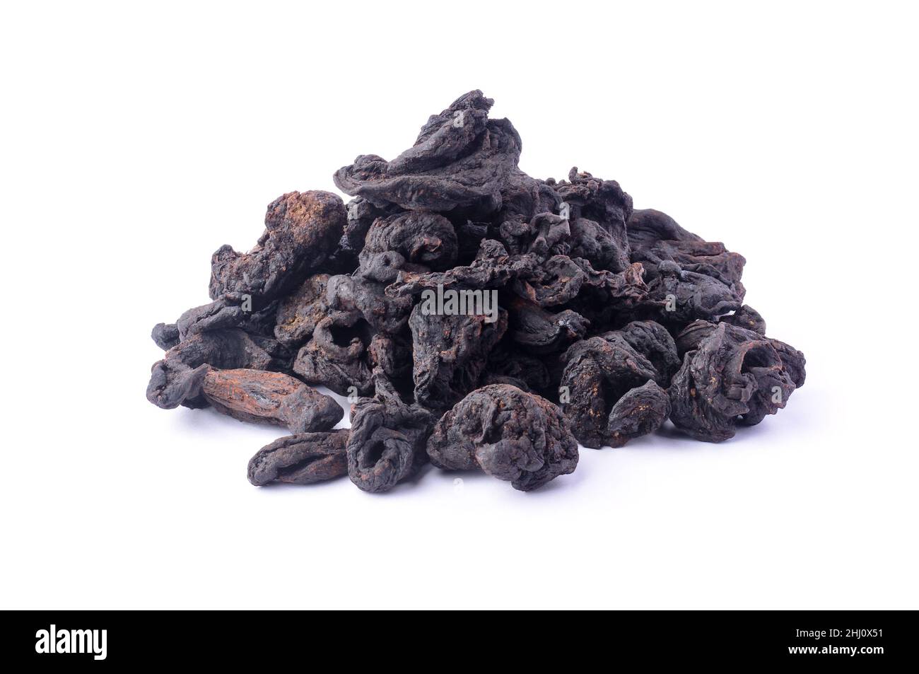 pile of sun dried garcinia fruits, black shriveled flavoring herb native to south asia, also known as brindle berry, goraka or malabar tamarind, isola Stock Photo