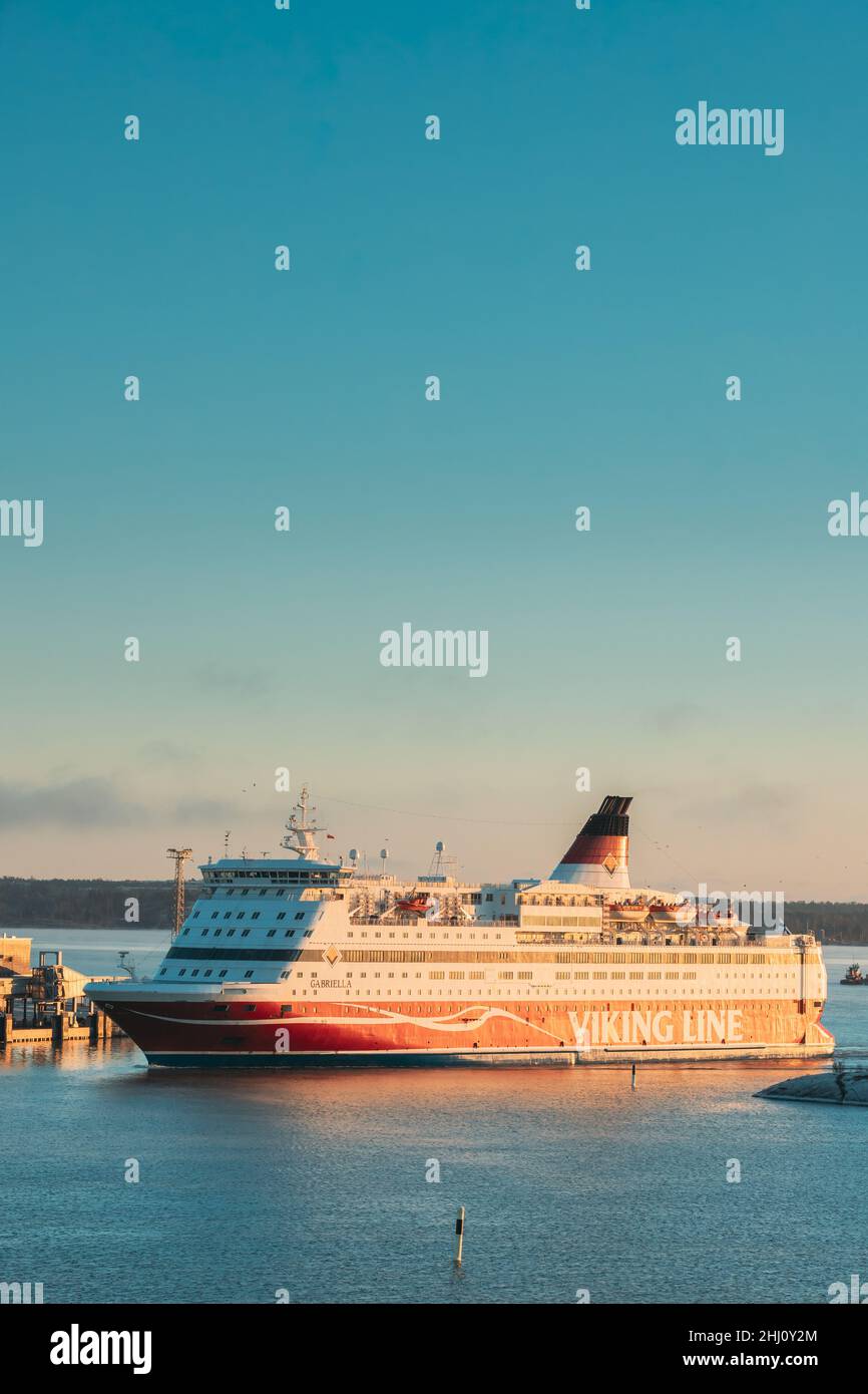 Helsinki, Finland. View Of Modern Ferry Ferryboat Viking Line Floating Near Blekholmen Valkosaari Island At Sunrise Sky. Stock Photo