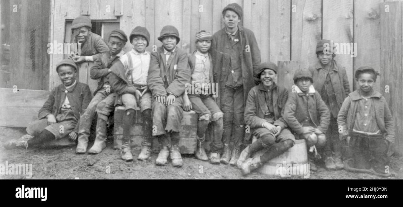 A group of African American children posing and smiling for a group photograph. Stock Photo