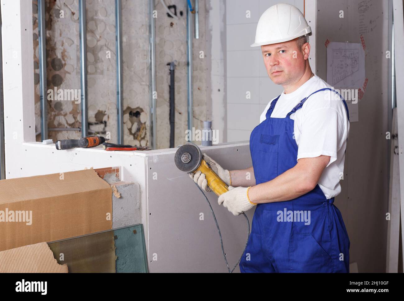 Contractor using angle grinder Stock Photo