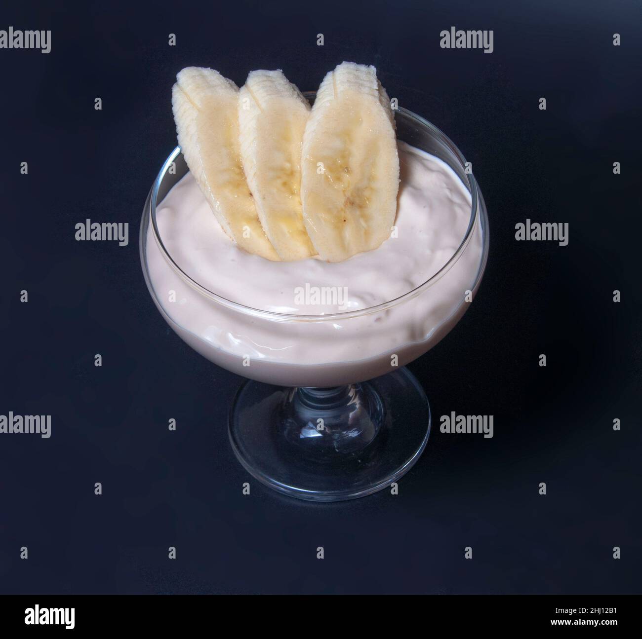 banana dessert in glass on black background Stock Photo