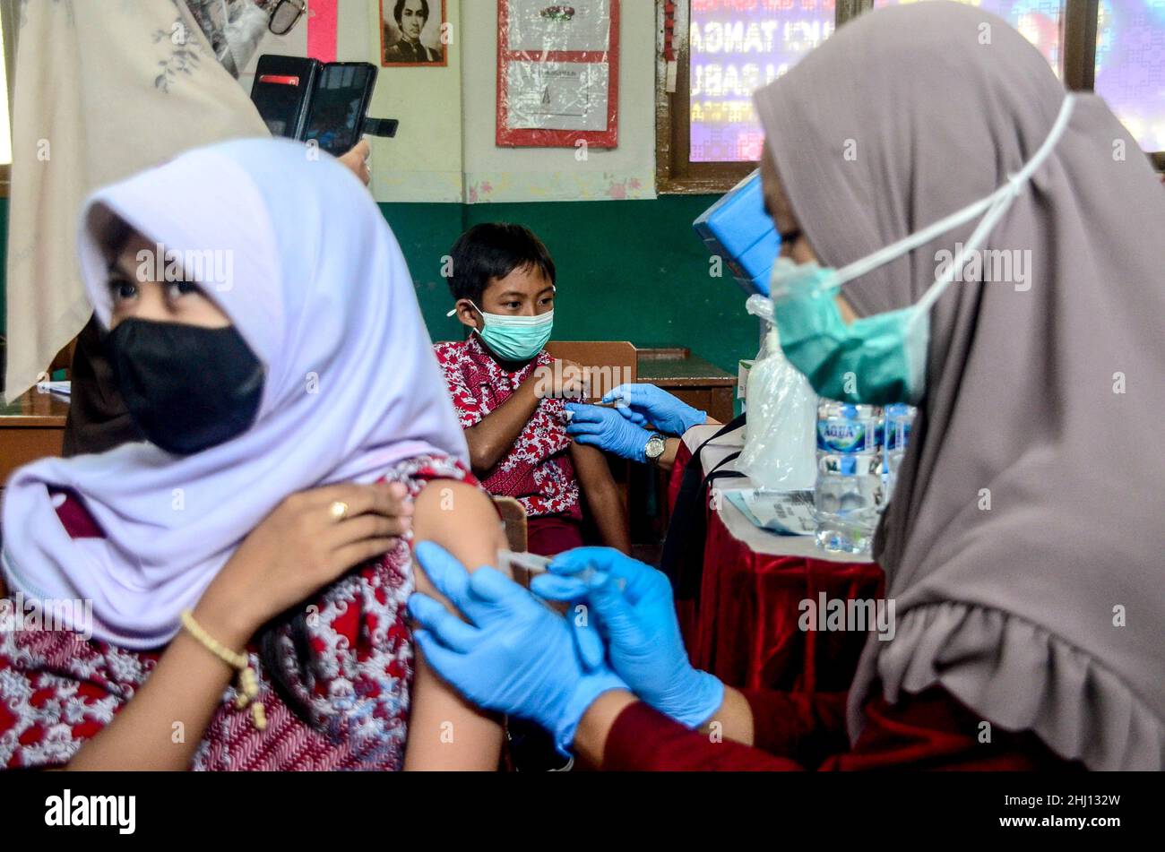 Bogor, Indonesia. 26th Jan, 2022. A health worker administers a dose of COVID-19 vaccine to a boy during vaccination for children aged 6 to 11 in Bogor, West Java, Indonesia, Jan. 26, 2022. Credit: Sandika Fadilah/Xinhua/Alamy Live News Stock Photo