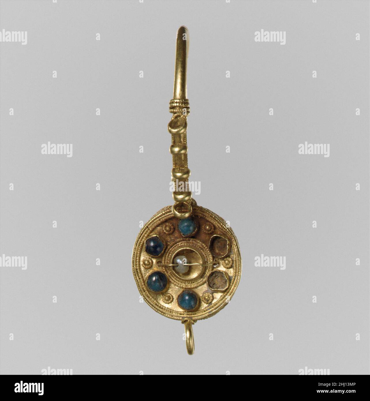 Earring 6th–7th century Langobardic or Byzantine (?) Fashionable in Italy for at least a century before the arrival of the Langobards, earrings of the “basket” variety, like the many shown in this case, quickly became part of Langobardic women’s dress.. Earring  469003 Stock Photo